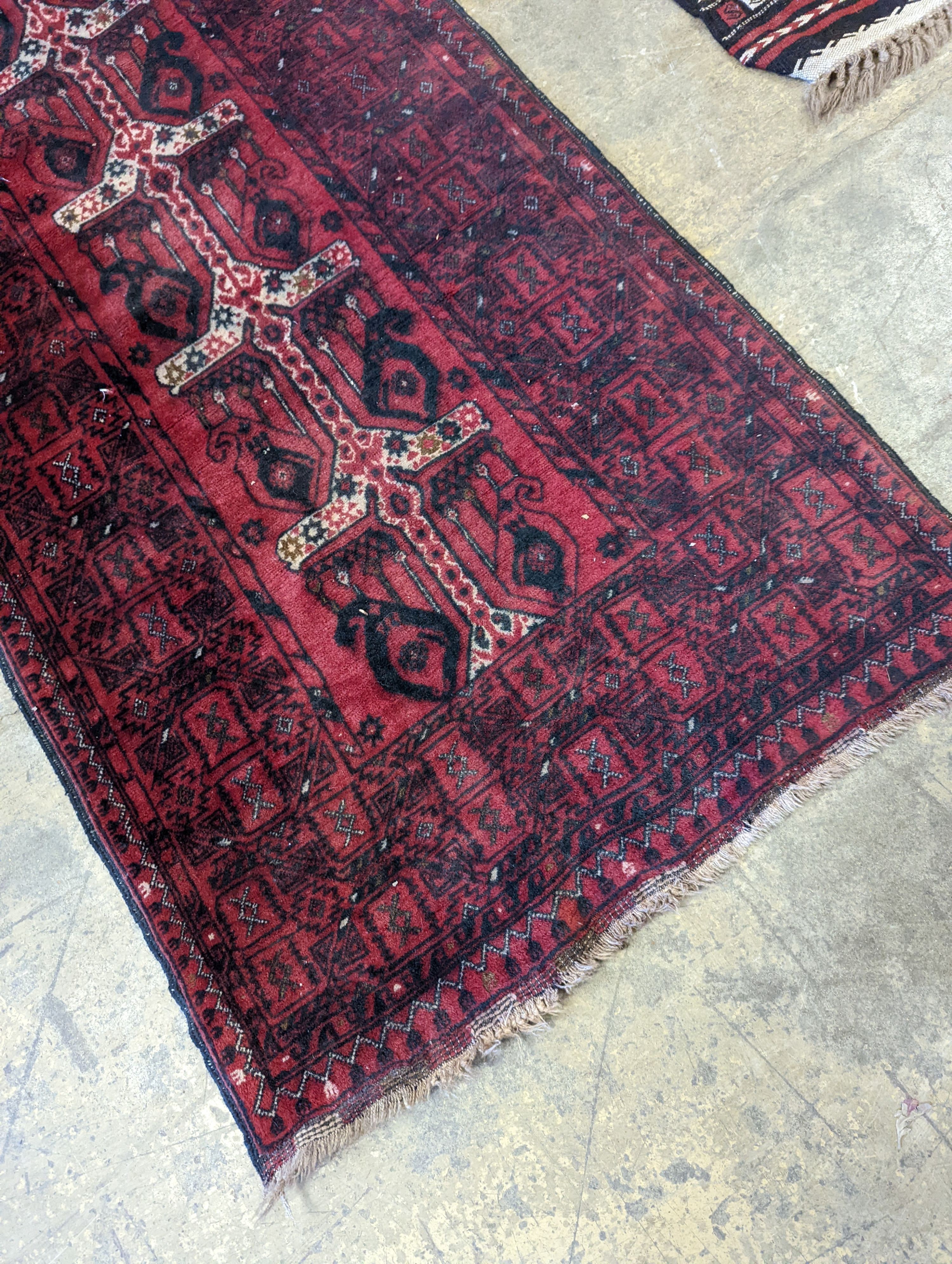 A Belouch red ground runner, 274 x 77cm